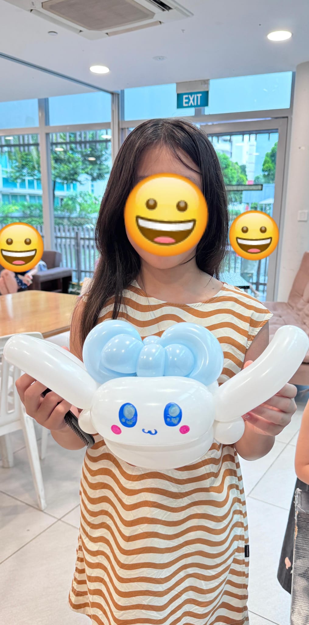 Children showing their colourful balloon creations at a birthday party