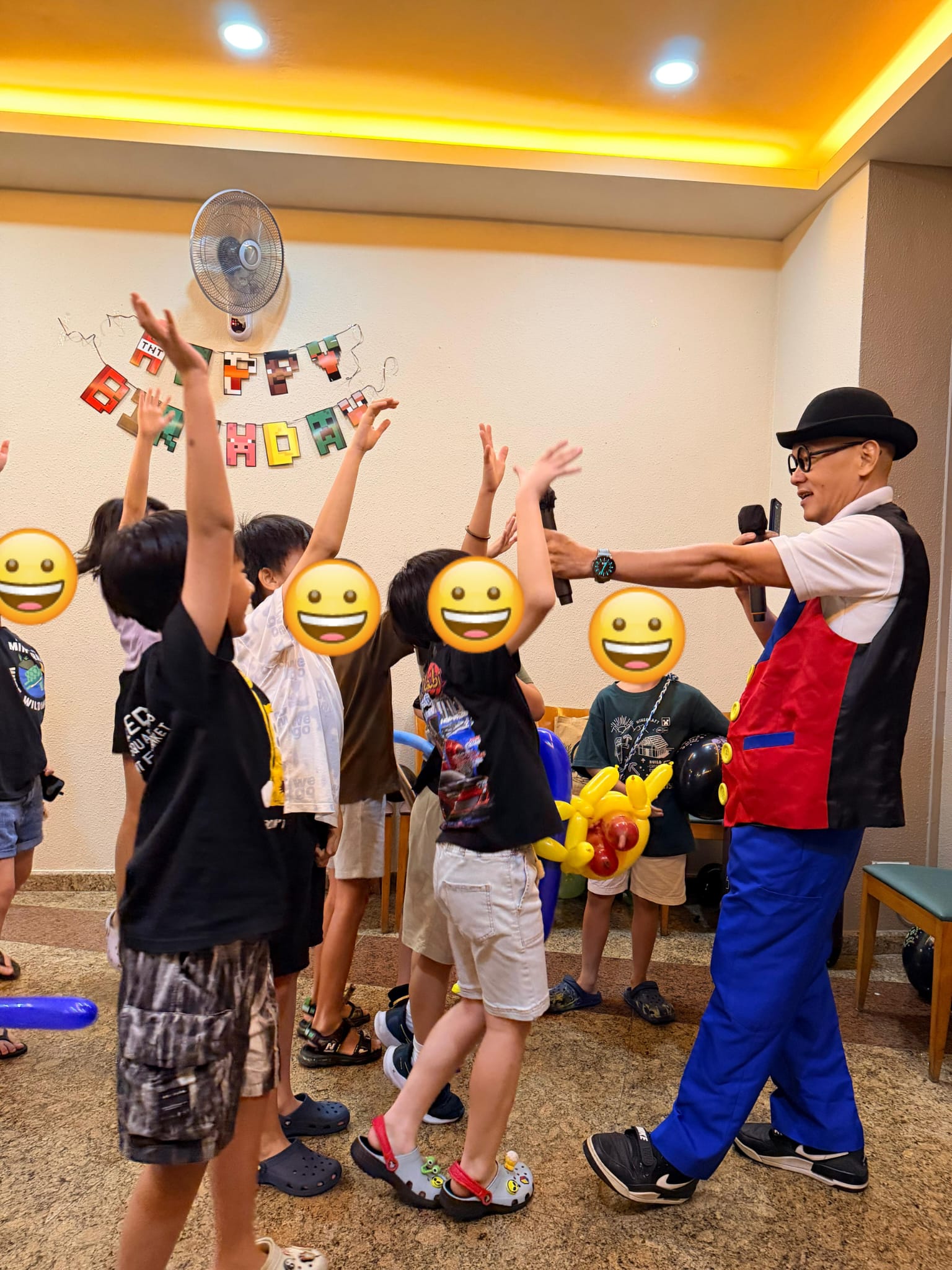 Children raising their hands during a hosted birthday party activity