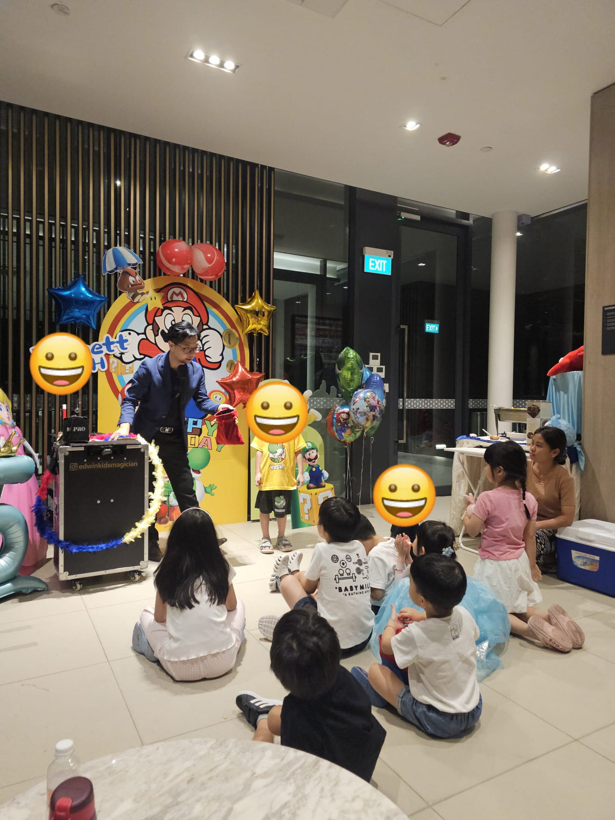 Magician performing with a child at a Mario-themed birthday party